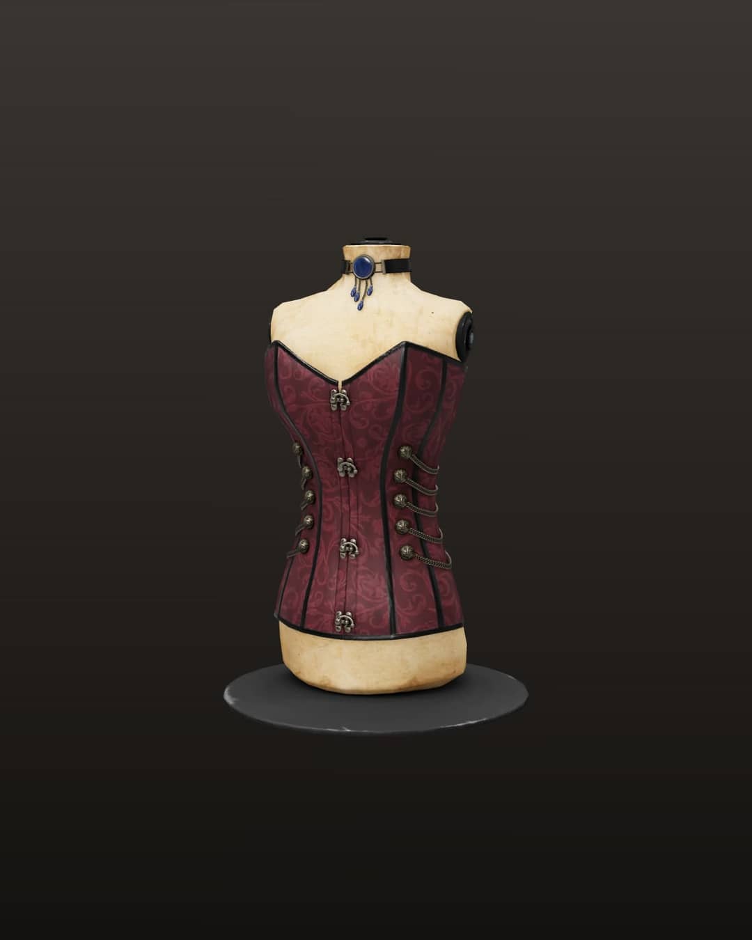 Áo corset gấm đỏ rượu vang có khuy móc kim loại, khoác trên ma-nơ-canh màu ngà, cổ đeo vòng đá xanh